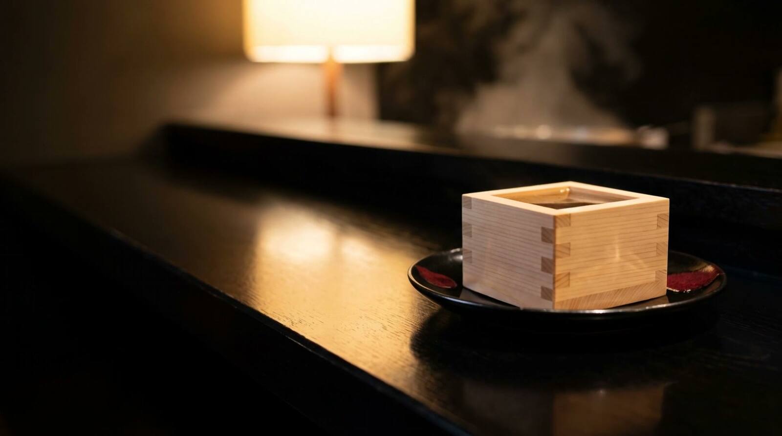A hinoki masu box of sake on the sushi counter